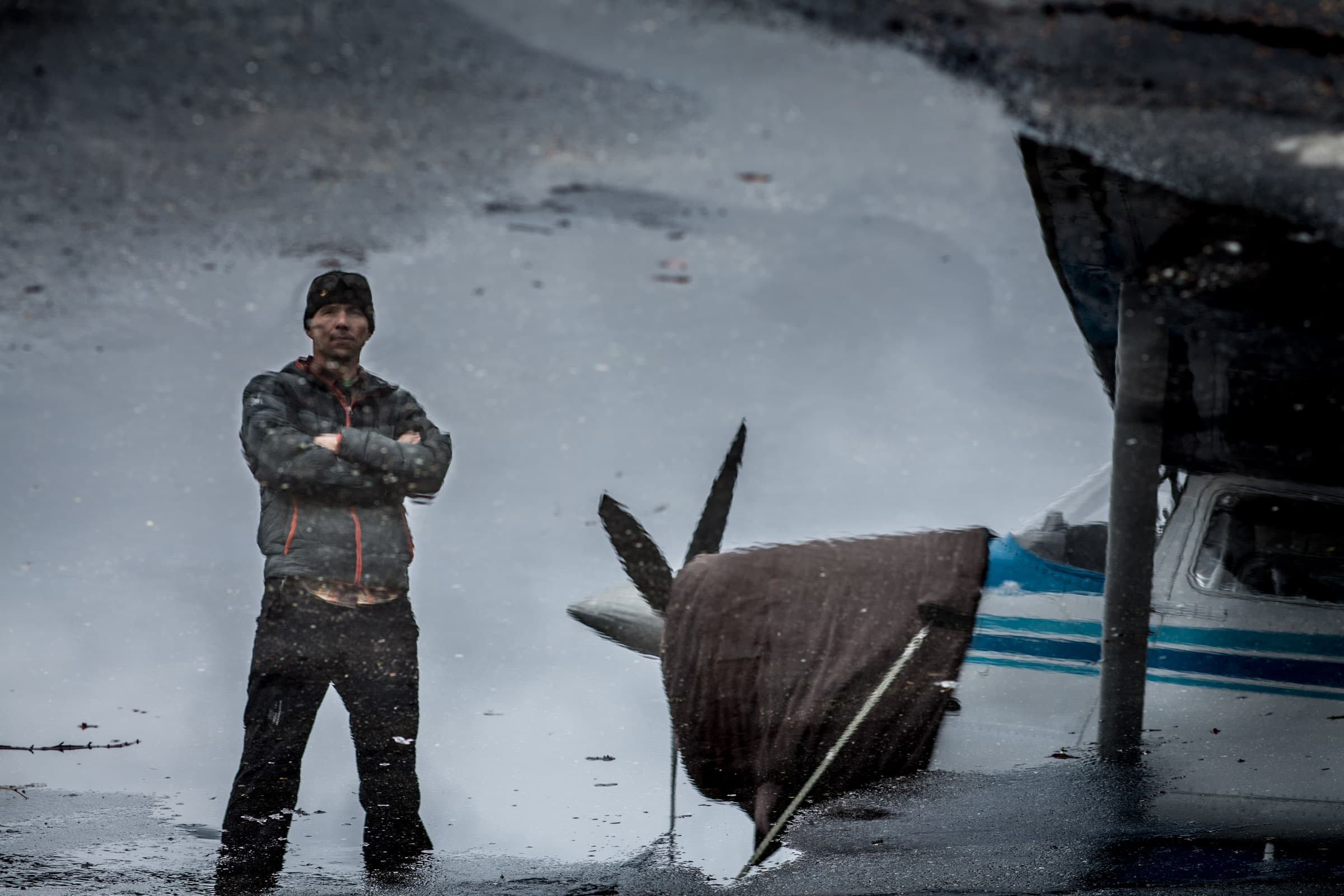 Chris Davenport reflected in a puddle at an Alaskan bush strip