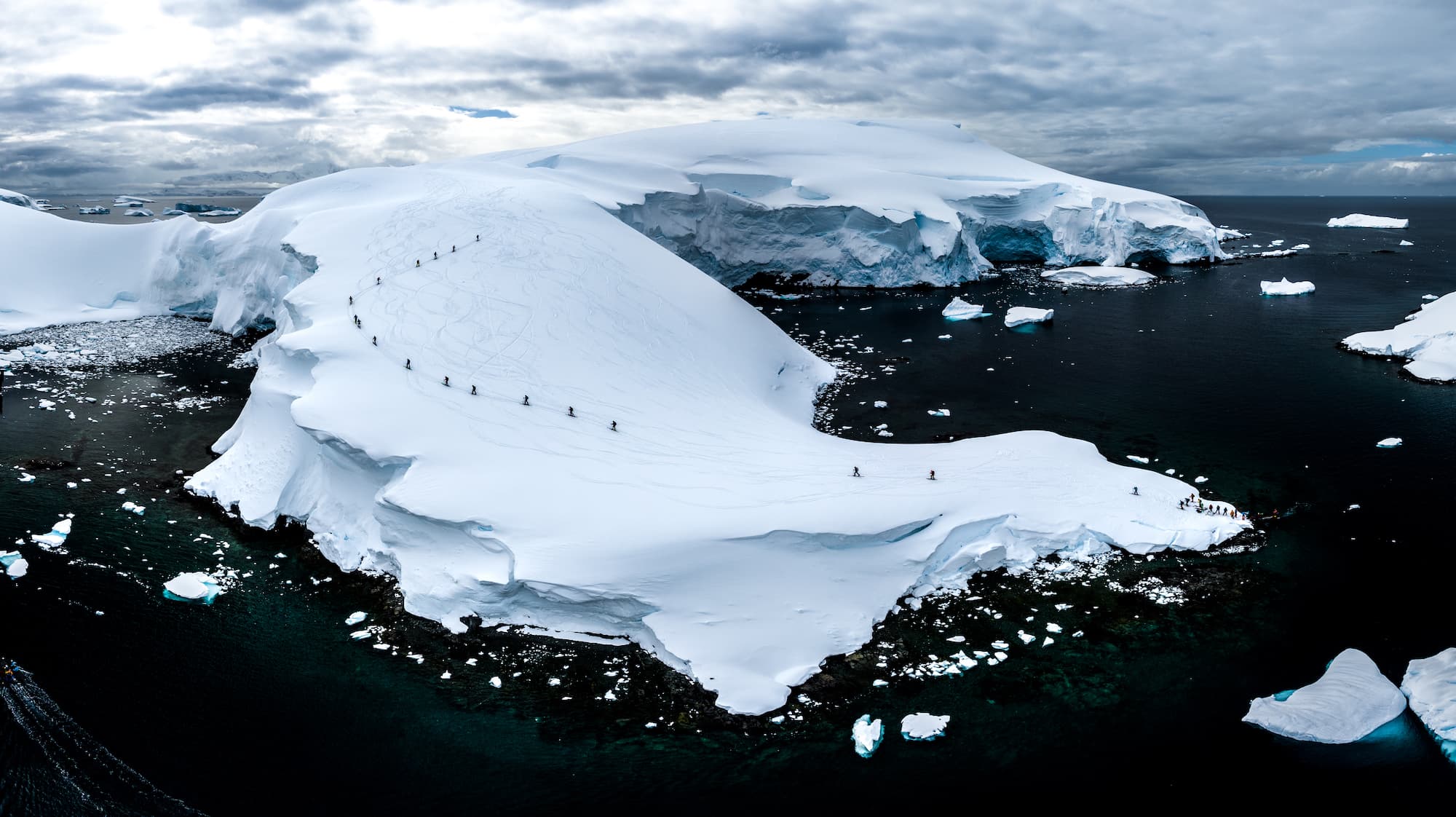 Aerial view of skiers descending an Antarctic ice island