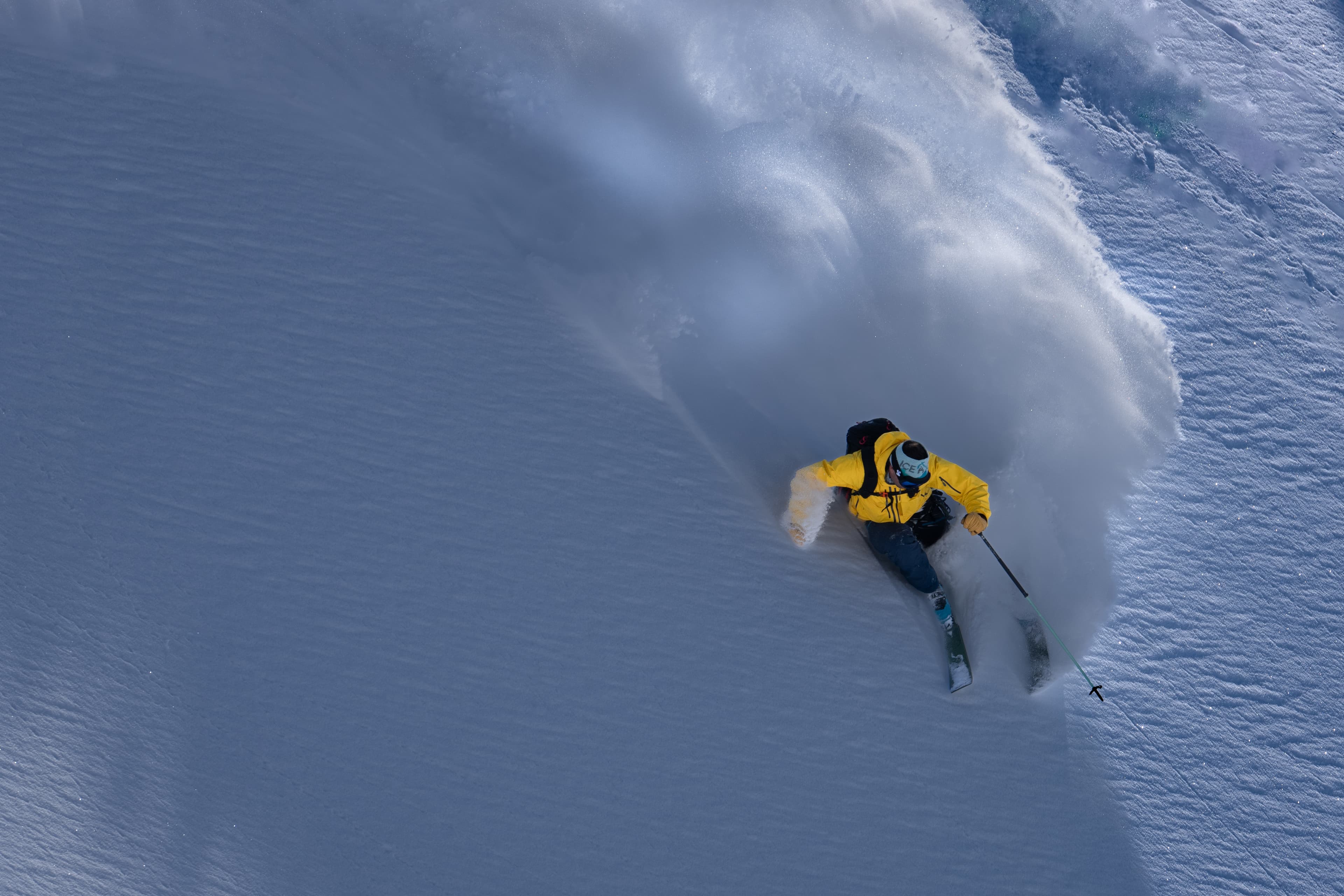 Chris Davenport powder blasting on a steep slope