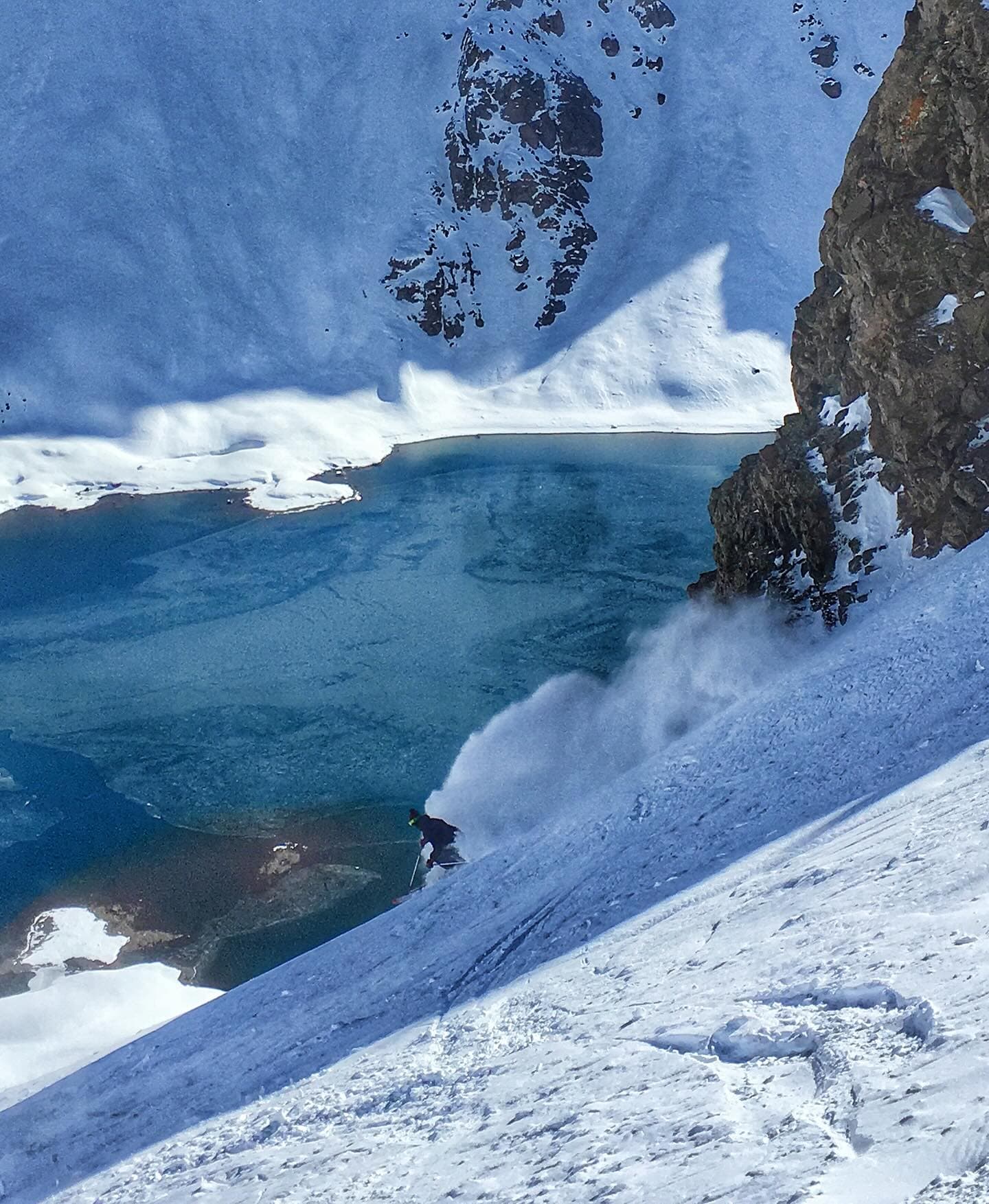 Skiing a steep couloir above the Portillo lake